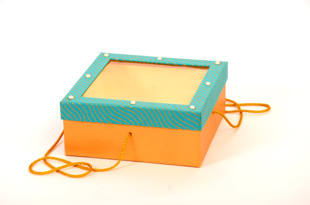 Handcrafted, square cake box in cardboard, blue & gold colors with golden strings.