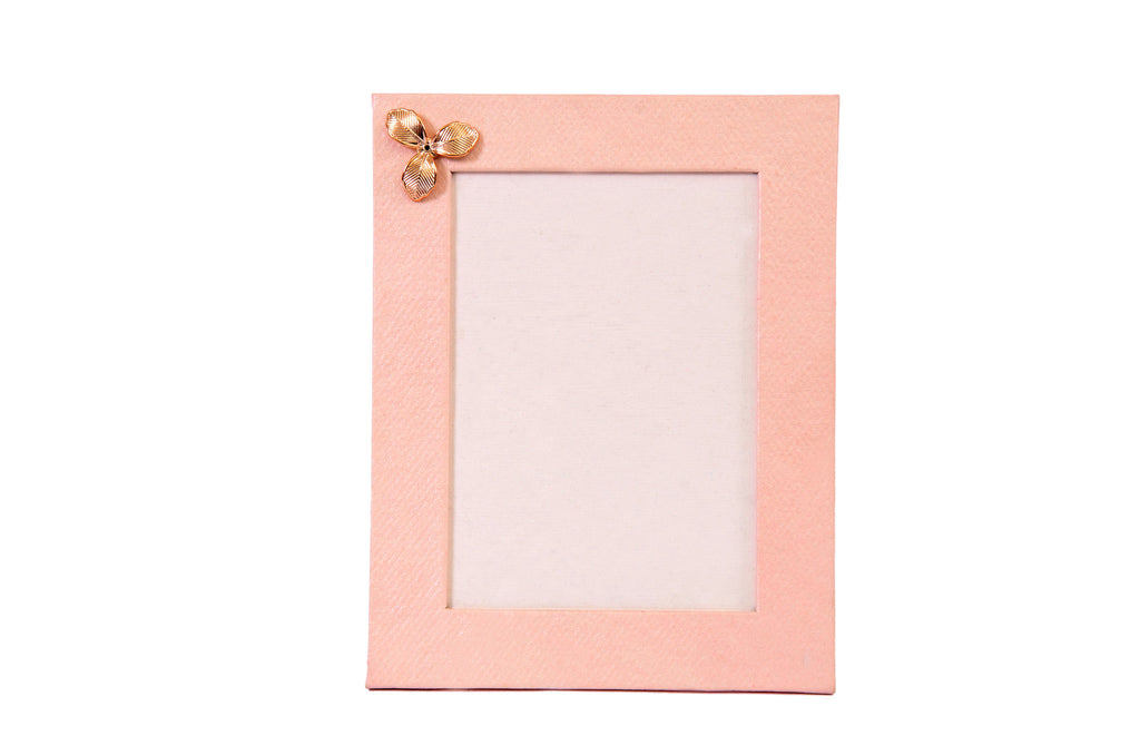 Handmade photo frame made in soft pink sheet with flower motif on top corner.