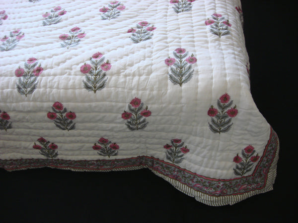 Handmade, reversible, cotton, block printed quilt in bright pink floral design