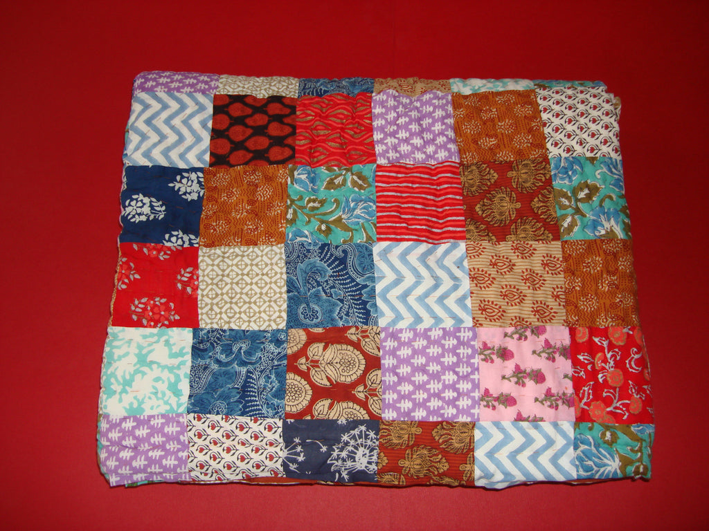 Handmade, patchwork cotton quilt in colorful shades in block prints