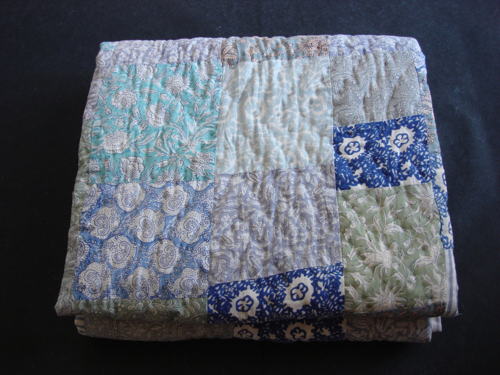 Handmade, patchwork cotton quilt in shades of grey, green and blue
