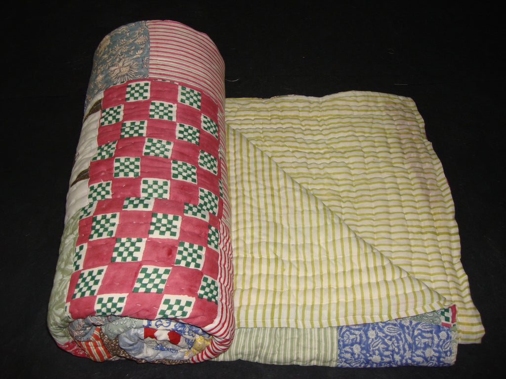 Handmade, patchwork cotton quilt in block prints supplemented with long stripes.