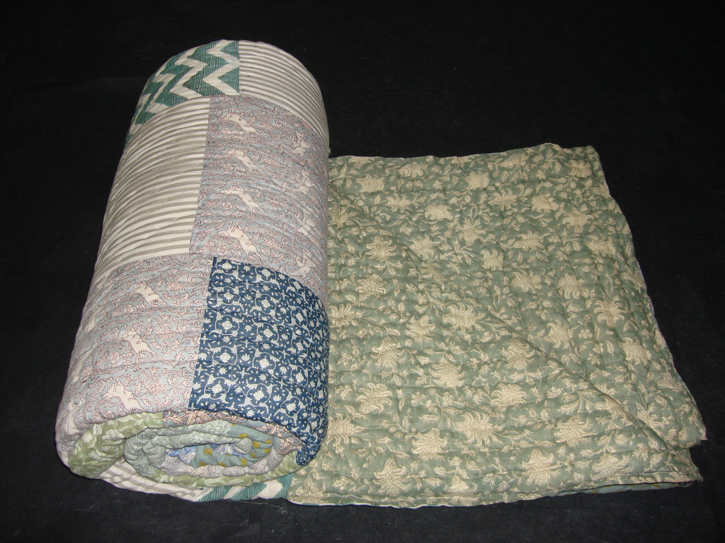 Handmade, patchwork cotton quilt in block prints with grey and blue in contrast with floral pattern.