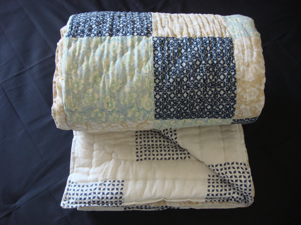 Handmade, patchwork cotton quilt in sequentially placed blocks