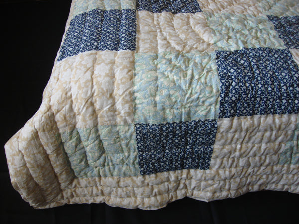 Handmade, patchwork cotton quilt in sequentially placed blocks